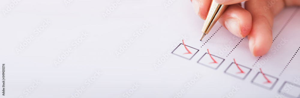 Businesswoman Writing On Checklist